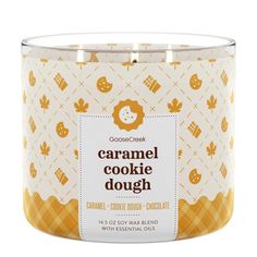 a cookie dough candle in a glass container with an orange and white pattern on it