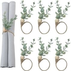 six napkin rings with flowers and leaves tied to them, each holding a single piece of string