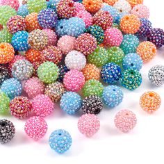 many different colors of beads on a white background