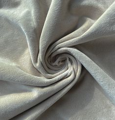 a close up shot of a white fabric textured with linens that is very soft