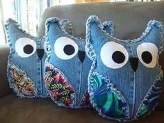 three pillows with eyes on them sitting on a couch