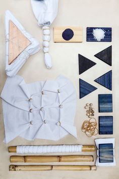 an assortment of items are displayed on a white tablecloth with blue and gold accents