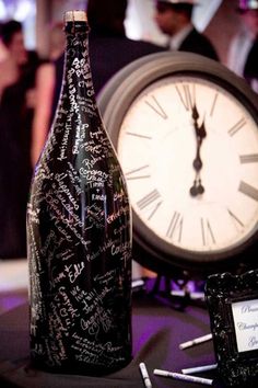 a bottle with writing on it next to a clock