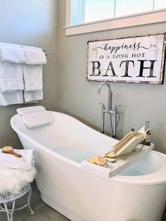 a white bath tub sitting next to a window