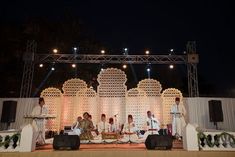 a group of people sitting on top of a stage