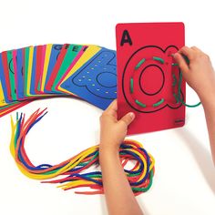 a child's hands holding a card with colored crayons on it and the cards are next to each other