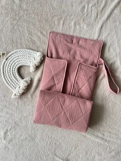 two pieces of pink linen with tassels laying on the ground next to each other