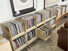 there are many records on the shelves next to each other in front of a flat screen tv