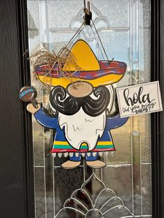 a glass door with a sign that says cola and a sombrero on it