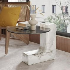 a table with books and vases on it in front of a window overlooking the city