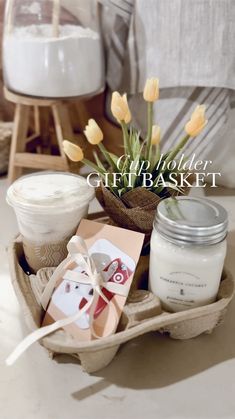 a basket filled with candles and flowers on top of a table