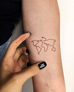 a woman's arm with a world map tattoo on it