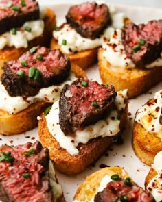 small pieces of bread with meat and cream on them