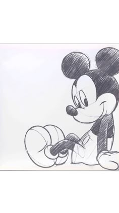 a drawing of mickey mouse sitting on the ground