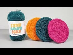 three balls of yarn sitting next to each other