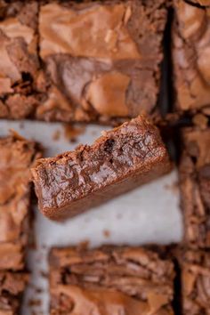 chocolate brownies are stacked on top of each other with one bite taken out of it