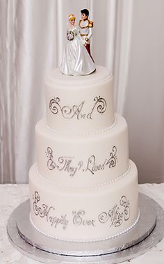 a wedding cake with a bride and groom figurine on top