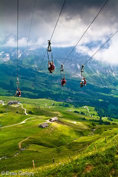 two people ride on the gondola with mountains in the background and text that reads go ziplining