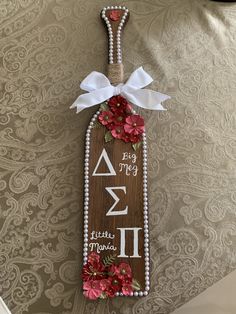 a wooden sign that has flowers on it