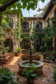 an outdoor courtyard with tables and chairs surrounded by greenery