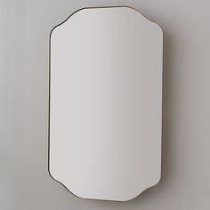 a mirror mounted to the side of a wall