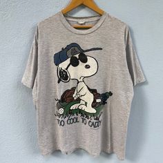 Details: *Vintage 90s joe cool snoopy tshirt *Size XL | Chest 24.5 inch / Length 30 inch * condition 8/10. No holes or rips. Only got stain at the shoulder and a small dot at the back. Please refer image above thank you ------------------------------------------ After purchase please leave phone number for shipping will ship using Fedex/DHL express  (Estimated to arrive 4-7 days only) If you have any questions regarding the item, feel free to contact any time. Customer satisfaction is our priority! Check out my other items & follow - new arrivals every day! https://kedainasvintage.etsy.com Snoopy, Snoopy Tshirt, Joe Cool Snoopy, Cool Snoopy, Snoopy Vintage, Snoopy Shirt, Joe Cool, Dhl Express, Vintage Finds