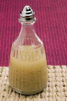 a glass bottle filled with liquid sitting on top of a mat