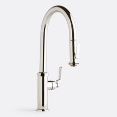 a kitchen faucet with two handles and nozzles on the side, against a white background