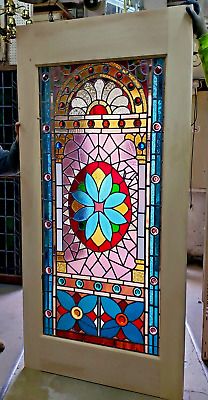 a colorful stained glass window sitting on top of a table