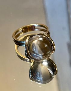 Rare 14k BRUTALIST MODERNIST POOLS OF LIGHT ROCK CRYSTAL GLASS ORB Ring!  in excellent condition! arrives in jewelry case and can be gifted immediately! crafted in solid 14k yellow gold - hallmarked and tested; came from Europe. weight approx 5.70g ; hand made solid gold - hammered like /organic surface - absolutely well made quality ring! orb is transparent and approx 12mm! GORGEOUS and RARE ring in excellent clean condition! smoke free environment; fast free USA priority insured shipping! for Magic Crystal Ball Ring, Luxury Brutalist Style Ring, Gold Cabochon Dome Ring, Timeless Gold Dome Ring With Cabochon, Gold Dome Ring With Cabochon, Formal Rings With Si Clarity And Round Cut, Formal Round Cut Ring With Si Clarity, Adjustable Round Clear Jewelry, Adjustable Clear Jewelry