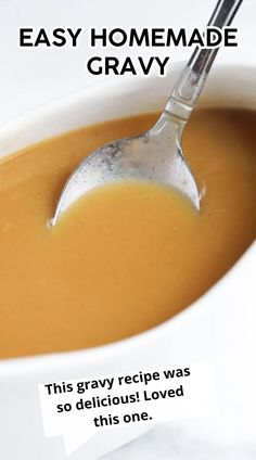 a white bowl filled with gravy and a spoon sticking out of the top