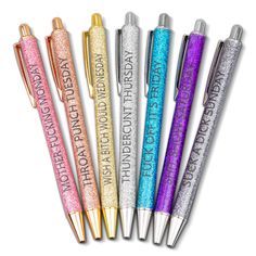 four pens with glitter writing on them