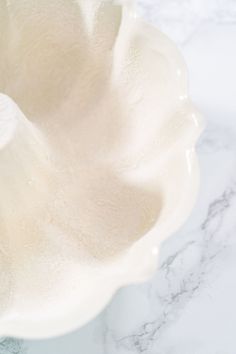 a white bowl sitting on top of a marble counter