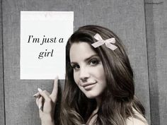 a woman holding up a sign that says i'm just a girl