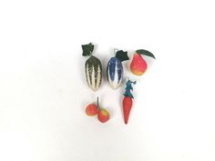 an assortment of miniature fruits and vegetables on a white surface with space for text or image