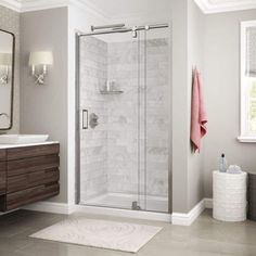 a bathroom with a walk in shower next to a sink