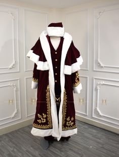 a robe is on display in a room with white walls and wood flooring,