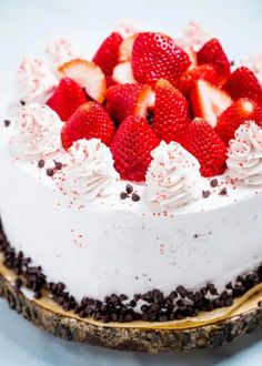 a white cake with strawberries and chocolate chips on top