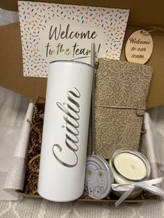 the welcome gift box is packed with candles and personalized items for guests to enjoy