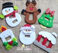 felt christmas decorations are laid out on a table with the letters e, b, c, and d