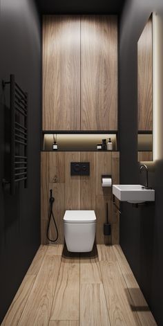 a modern bathroom with wood paneling and white fixtures, including a toilet and sink