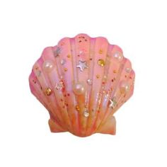 a pink shell with stars and pearls on it