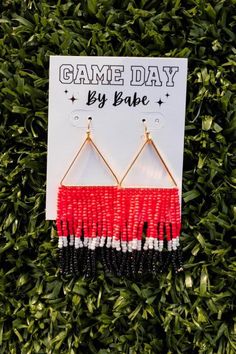 "Step up your game day style with these beaded earrings! Turn heads and show your team spirit with these fan favorite accessories. Perfect for adding a touch of fun and flair to any outfit. Game day just got a whole lot more fashionable!" Earring Inspo, Team Spirit, Step Up, Game Day, Beaded Earrings, Turn Ons, Fan, Bead Earrings