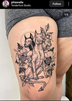 a woman's thigh with an image of two dogs and flowers on the side