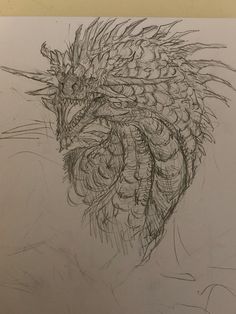 a pencil drawing of a dragon head with sharp claws on it's back end