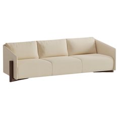 a white couch with four cushions on it's back and arms, viewed from the front