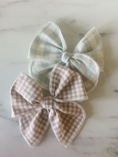 Featuring Summer Plaid. Discover the perfect accessory for your little one with our handmade bows, crafted with love and care from 100% cotton material. Each bow features a plaid or gingham cotton fabric of your choice! Available in a bigger gingham pattern, in a mist Blue, or a tiny checkered gingham in a sandy beige. Measuring 4.5 inches wide, these bows are designed to add a touch of charm to any outfit. You can choose between an Alligator Clip or Nylon Headband, ensuring comfort and convenience for your child. Please note, these bows are lovingly made for daytime wear and are not suitable for sleeping. Woman Costumes, Summer Plaid, Diy Toddler, Toddler Bows, Best Kids Toys, Bow Making, Gingham Pattern, Baby Bow