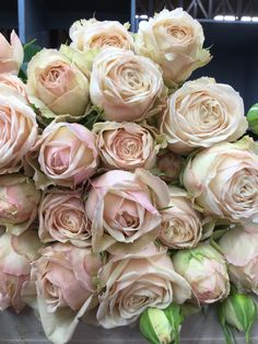 a large bouquet of pink roses on display