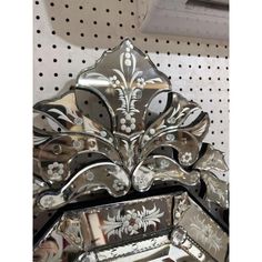 an ornately designed mirror on display in a store