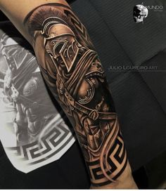 a man's arm with a tattoo on it that has an image of a roman soldier